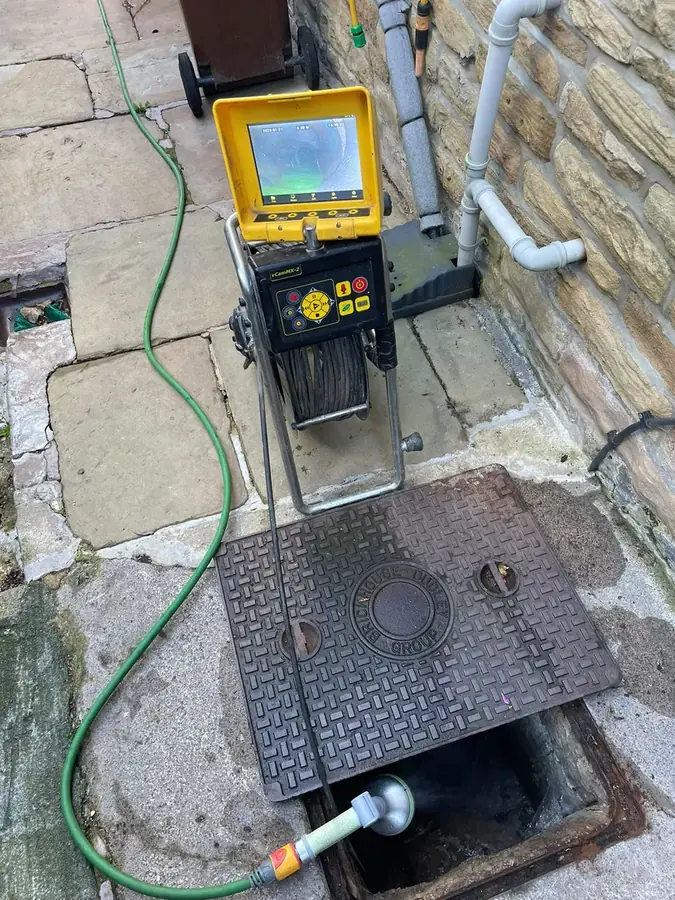 CCTV drain survey unit set up over an open chamber on Church Street, Barrowford